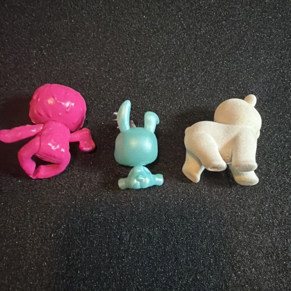 three small collectible toy figurines: Baby Crystals, Bounce Scribble Scrubbie k